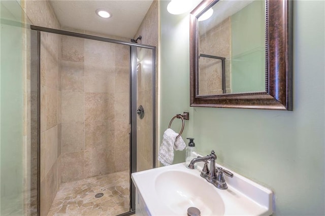 5608 Outlook St, Mission, KS 66202 - full bathroom featuring a sink, a stall shower, and recessed lighting