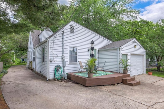 5608 Outlook St, Mission, KS 66202 - rear view of house with a garage, an outdoor structure, roof with shingles, and concrete driveway