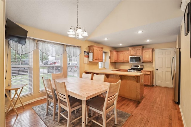 13825 Woodmont Ave, Bonner Springs, KS 66012 - dining area with lofted ceiling, light wood-style flooring, a chandelier, baseboards, and recessed lighting