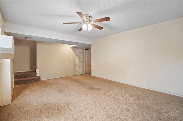 13825 Woodmont Ave, Bonner Springs, KS 66012 - unfurnished room featuring light colored carpet, stairway, a ceiling fan, and a textured ceiling