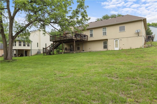 13825 Woodmont Ave, Bonner Springs, KS 66012 - back of house featuring stairway, a deck, a lawn, and central AC