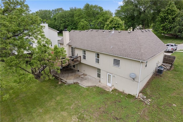 13825 Woodmont Ave, Bonner Springs, KS 66012 - rear view of property with a shingled roof, a patio area, a chimney, a deck, and a yard
