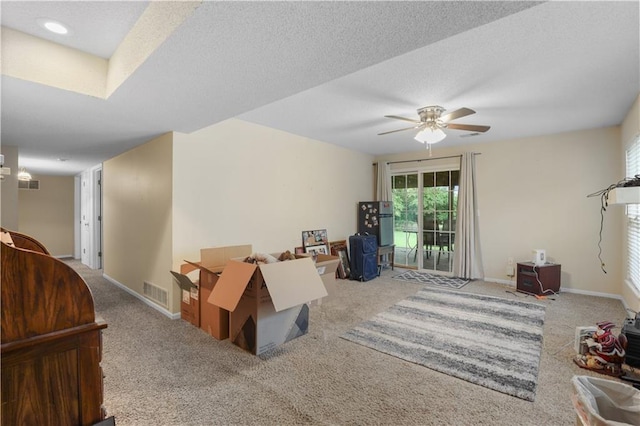 13825 Woodmont Ave, Bonner Springs, KS 66012 - carpeted living area with a ceiling fan and baseboards