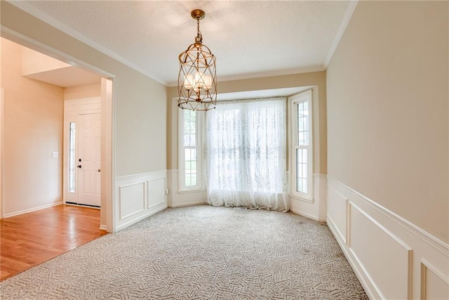 16482 W 132nd Cir, Olathe, KS 66062 - carpeted spare room with crown molding, wainscoting, a chandelier, a decorative wall, and a textured ceiling