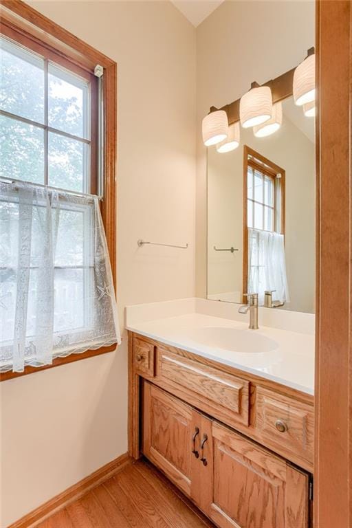 16482 W 132nd Cir, Olathe, KS 66062 - bathroom with vanity, wood finished floors, and baseboards