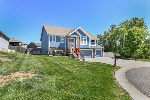 2511 E Maple Ct, Tonganoxie, KS 66086 - raised ranch featuring concrete driveway, an attached garage, and stone siding
