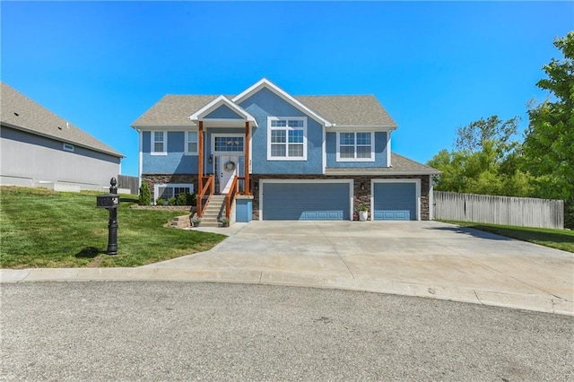 2511 E Maple Ct, Tonganoxie, KS 66086 - split foyer home with a garage, stone siding, and concrete driveway