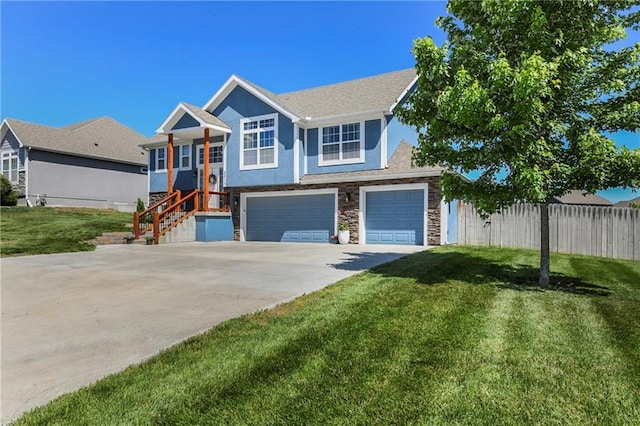 2511 E Maple Ct, Tonganoxie, KS 66086 - view of front of home with stone siding, concrete driveway, a garage, and stucco siding