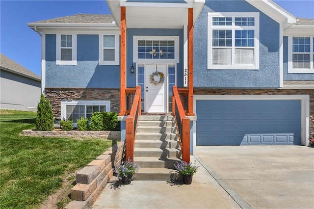2511 E Maple Ct, Tonganoxie, KS 66086 - view of front facade featuring stone siding, stucco siding, a garage, concrete driveway, and a front yard