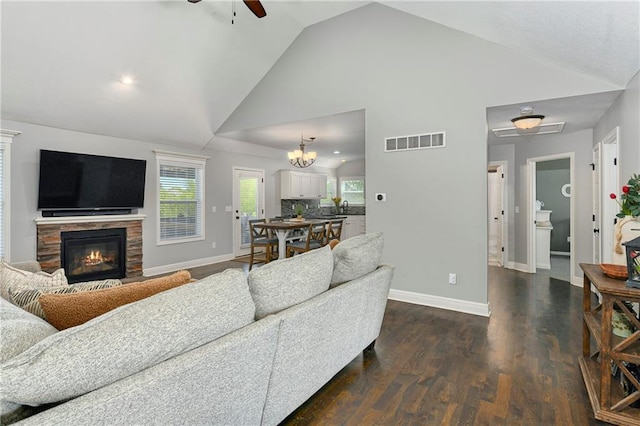2511 E Maple Ct, Tonganoxie, KS 66086 - living area with ceiling fan, baseboards, a stone fireplace, high vaulted ceiling, and dark wood-style floors
