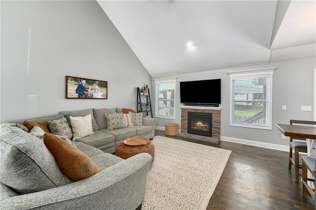 2511 E Maple Ct, Tonganoxie, KS 66086 - living room with dark wood-type flooring, baseboards, a fireplace with flush hearth, and high vaulted ceiling