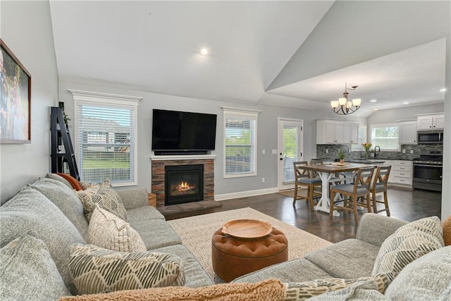 2511 E Maple Ct, Tonganoxie, KS 66086 - living room with lofted ceiling, a chandelier, dark wood finished floors, a fireplace, and recessed lighting
