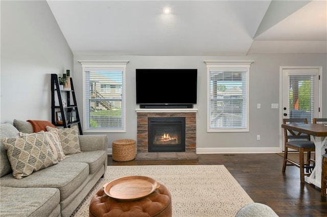 2511 E Maple Ct, Tonganoxie, KS 66086 - living room with lofted ceiling, plenty of natural light, dark wood finished floors, baseboards, and a warm lit fireplace