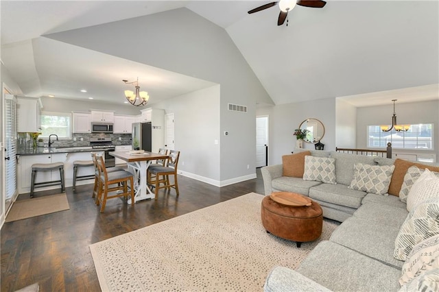 2511 E Maple Ct, Tonganoxie, KS 66086 - living area featuring a chandelier, a ceiling fan, dark wood-type flooring, and high vaulted ceiling