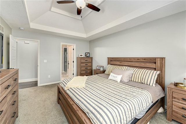2511 E Maple Ct, Tonganoxie, KS 66086 - carpeted bedroom with a raised ceiling, baseboards, a ceiling fan, and connected bathroom