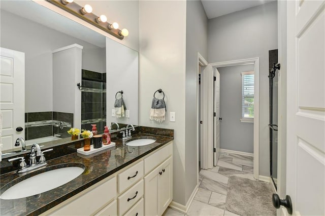 2511 E Maple Ct, Tonganoxie, KS 66086 - full bath featuring marble look tile flooring, tiled shower, double vanity, and baseboards