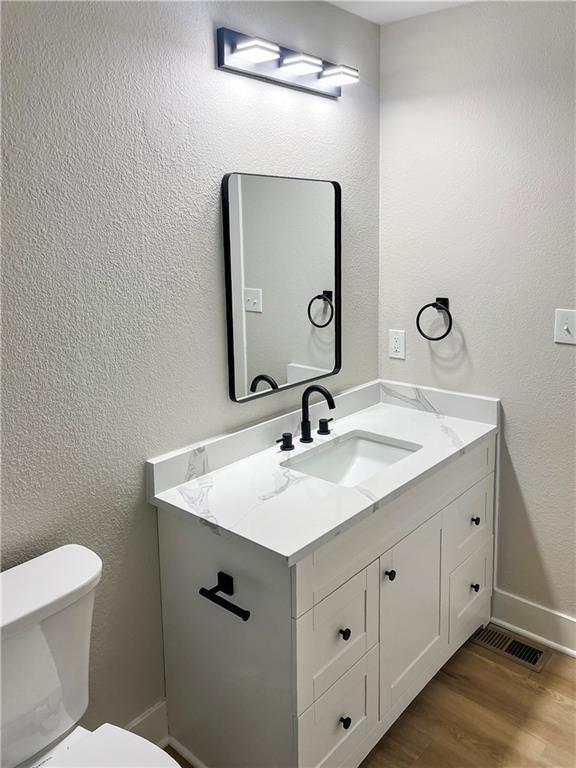 19213 E 15th Terrace Ct N, Independence, MO 64056 - bathroom with vanity and wood finished floors