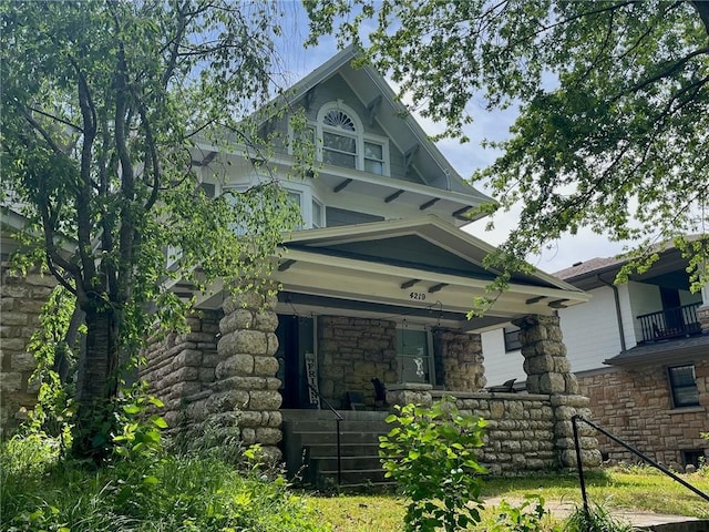 4219 Kenwood Ave, Kansas City, MO 64110 - victorian-style house with a porch and stone siding