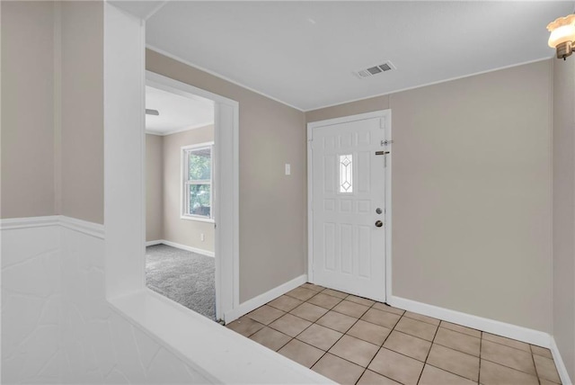 712 NE 45th St, Kansas City, MO 64116 - foyer featuring baseboards, light tile patterned flooring, and ornamental molding