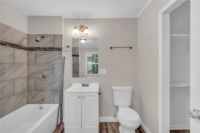 712 NE 45th St, Kansas City, MO 64116 - full bath with vanity,  shower combination, toilet, and wood finished floors