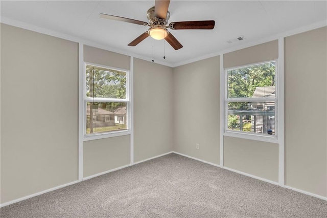 712 NE 45th St, Kansas City, MO 64116 - unfurnished room featuring carpet, plenty of natural light, a ceiling fan, and baseboards