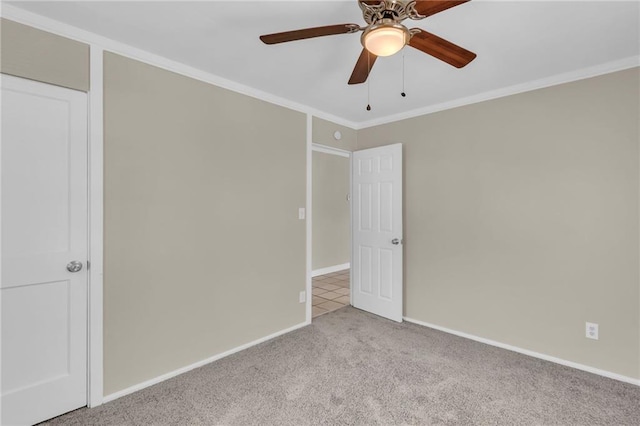 712 NE 45th St, Kansas City, MO 64116 - spare room with carpet, ornamental molding, a ceiling fan, and baseboards