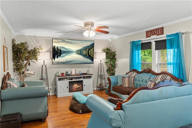 15205 E 40th St S, Independence, MO 64055 - living room with ceiling fan, ornamental molding, wood finished floors, and a lit fireplace