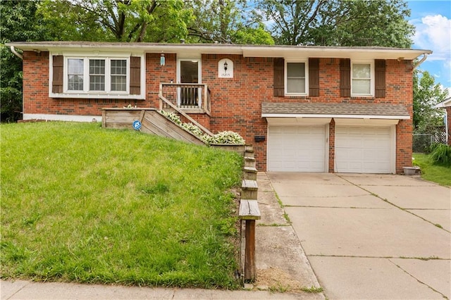 15205 E 40th St S, Independence, MO 64055 - view of front of home featuring an attached garage, brick siding, a front yard, and driveway