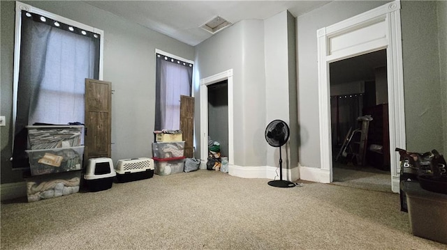 living area featuring carpet floors and baseboards