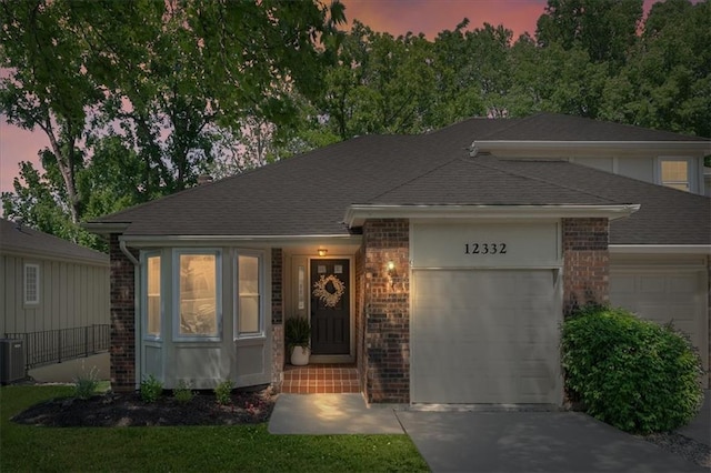 12332 W 105th Ter, Overland Park, KS 66215 - view of front of property with a garage, concrete driveway, and a shingled roof