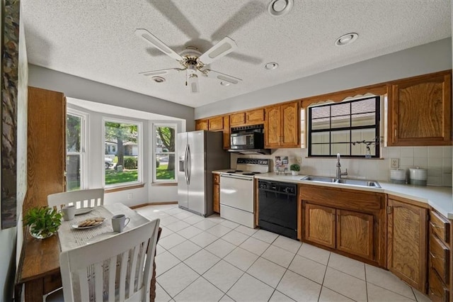 12332 W 105th Ter, Overland Park, KS 66215 - kitchen with black appliances, a sink, brown cabinetry, light countertops, and a textured ceiling