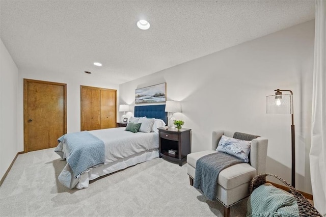 12332 W 105th Ter, Overland Park, KS 66215 - bedroom with a textured ceiling, carpet floors, recessed lighting, two closets, and baseboards