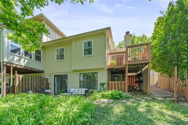 12332 W 105th Ter, Overland Park, KS 66215 - rear view of property featuring board and batten siding, a wooden deck, and an outdoor living space