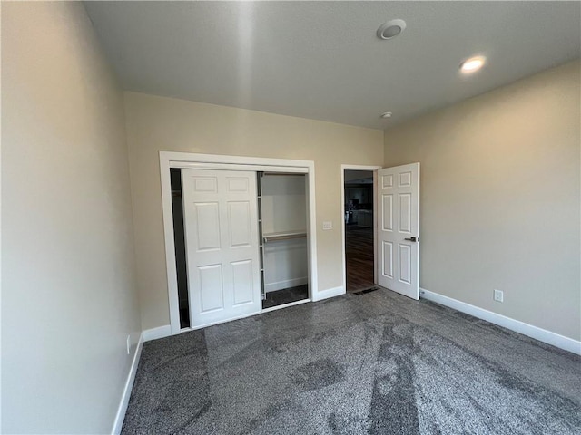 2320 NE 72nd St, Kansas City, MO 64118 - unfurnished bedroom featuring dark carpet, baseboards, and a closet