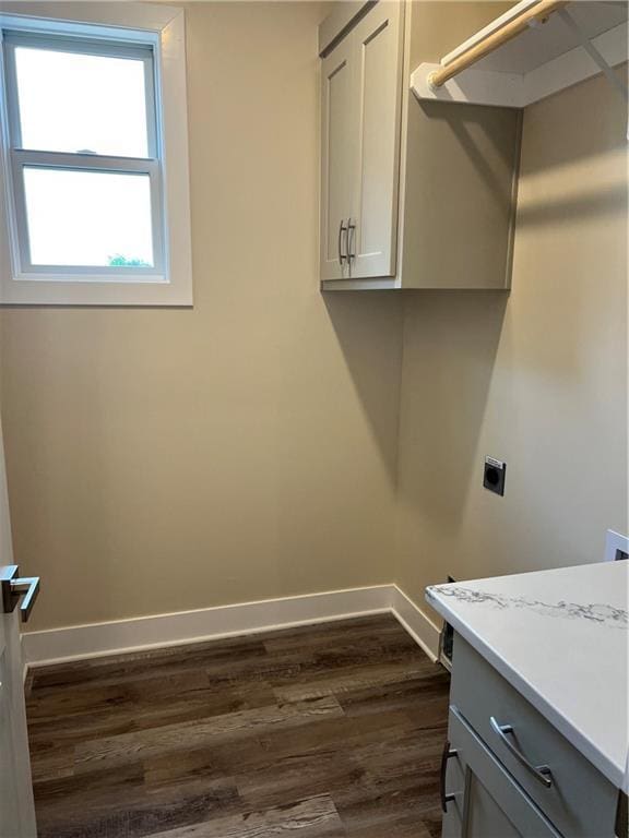 2320 NE 72nd St, Kansas City, MO 64118 - washroom featuring hookup for an electric dryer, dark wood-style flooring, baseboards, and cabinet space