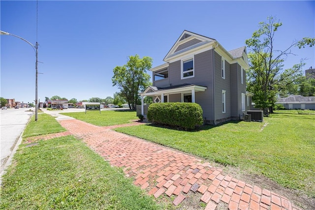 915 Main St, Neodesha, KS 66757 - view of property exterior featuring central AC unit and a lawn