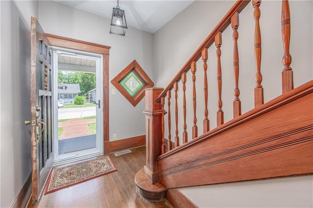 915 Main St, Neodesha, KS 66757 - entryway with hardwood / wood-style floors, baseboards, and stairway