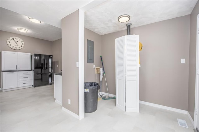 915 Main St, Neodesha, KS 66757 - hall featuring electric panel, light flooring, and baseboards