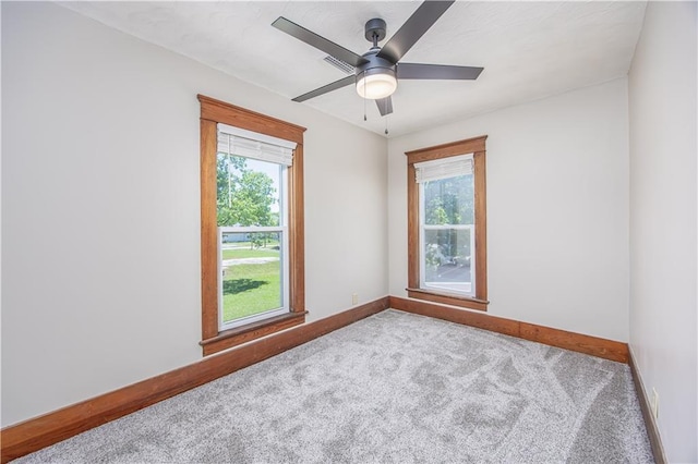 915 Main St, Neodesha, KS 66757 - carpeted spare room featuring baseboards, plenty of natural light, and ceiling fan