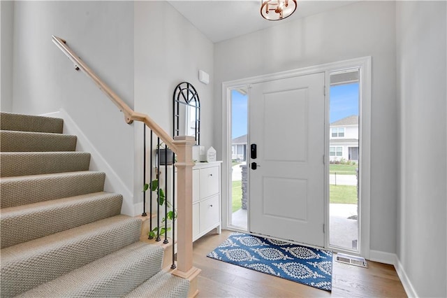19629 W 196th St, Spring Hill, KS 66083 - entryway with stairway, wood finished floors, a chandelier, and baseboards