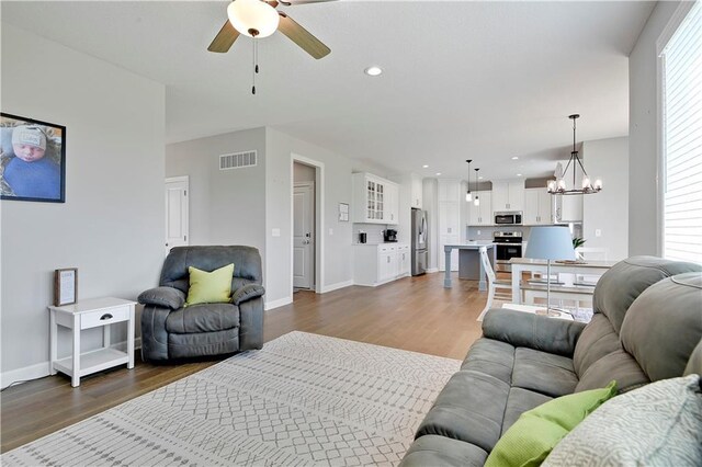 19629 W 196th St, Spring Hill, KS 66083 - living area featuring a ceiling fan, a chandelier, dark wood-style flooring, baseboards, and recessed lighting