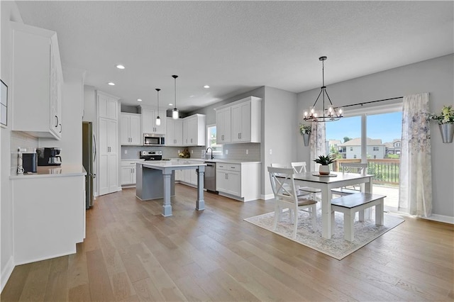 19629 W 196th St, Spring Hill, KS 66083 - kitchen with appliances with stainless steel finishes, healthy amount of natural light, a chandelier, decorative backsplash, and recessed lighting
