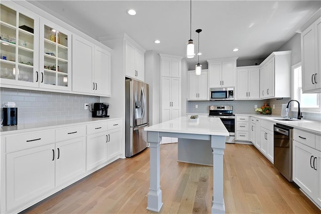 19629 W 196th St, Spring Hill, KS 66083 - kitchen with appliances with stainless steel finishes, a sink, decorative backsplash, light wood-type flooring, and white cabinets