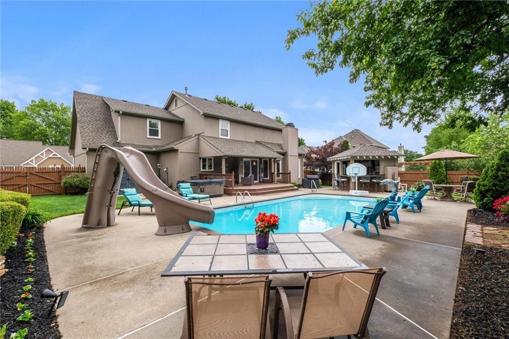 712 SW Benjamin Dr, Lees Summit, MO 64081 - view of pool featuring a water slide, a patio area, and outdoor dining area