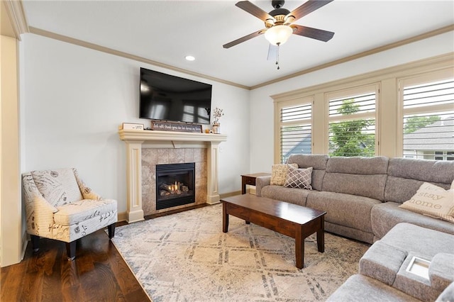 24318 W 91st Pl, Lenexa, KS 66227 - living area with wood finished floors, ceiling fan, ornamental molding, a tiled fireplace, and baseboards