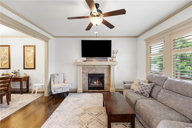 24318 W 91st Pl, Lenexa, KS 66227 - living room with dark wood-style floors, a ceiling fan, a tile fireplace, crown molding, and baseboards