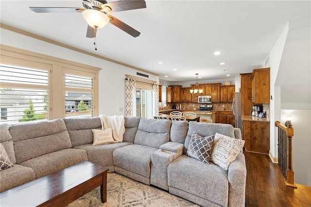 24318 W 91st Pl, Lenexa, KS 66227 - living room featuring dark wood-type flooring, recessed lighting, a ceiling fan, and ornamental molding