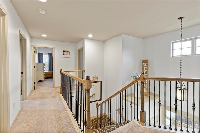 24318 W 91st Pl, Lenexa, KS 66227 - hall with an upstairs landing, recessed lighting, light colored carpet, baseboards, and a chandelier
