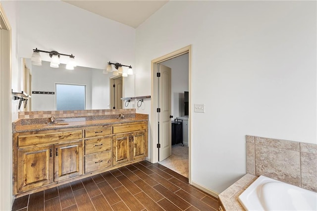 24318 W 91st Pl, Lenexa, KS 66227 - bathroom with double vanity, a bath, and wood finished floors