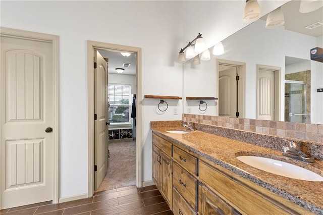 24318 W 91st Pl, Lenexa, KS 66227 - bathroom with double vanity, a stall shower, wood finish floors, and baseboards